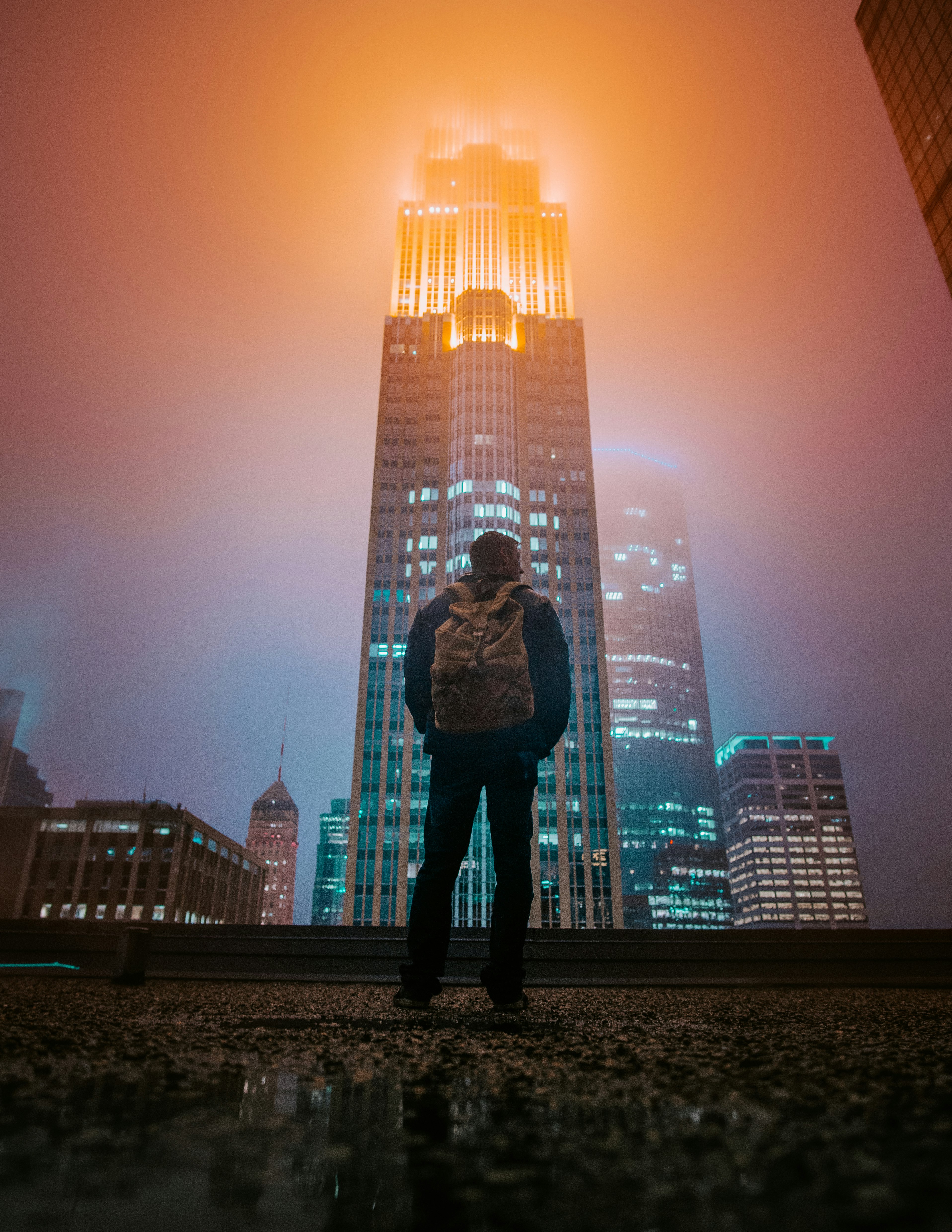 man standing while facing building